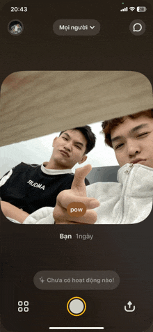 a phone screen shows two men giving a thumbs up sign