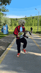 a man in a red jacket is holding a wrestling ring