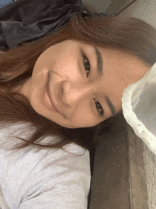 a woman laying down with a plastic bag on her face