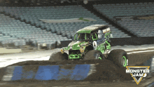 a monster jam truck is driving through a dirt track