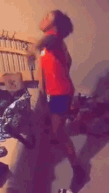 a girl in a red shirt with the number 8 on it is dancing