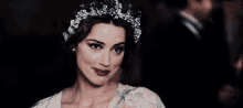 a woman with flowers in her hair is smiling and clapping