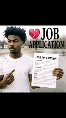 a man is holding a job application with a broken heart on it