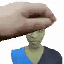 a hand is holding a person 's head in a pixel art .