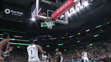 a basketball game is being played in front of a frost bank center banner