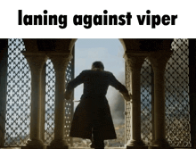 a man in a trench coat is walking through a doorway with the words laning against viper above him