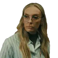 a woman wearing glasses and a striped shirt looks angry