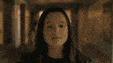a close up of a girl 's face in a hallway looking at the camera
