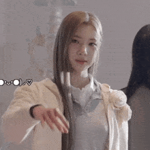 a girl making a heart shape with her hands in front of her face
