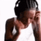 a woman wearing headphones is listening to music .