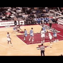 a basketball game is being played in front of an american airlines banner