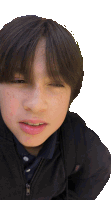 a young boy with freckles on his face and a black jacket