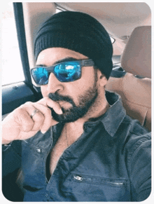 a man with a beard wearing sunglasses and a hat