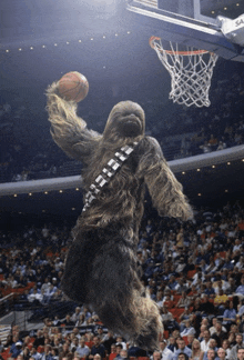 chewbacca is dunking a basketball in front of a crowd at a basketball game