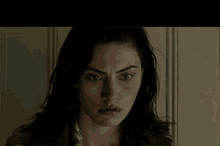a close up of a woman 's face with dark hair