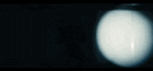 a green light is shining on a black wall