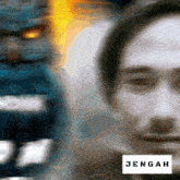 a blurry picture of a man with the word jenah on the bottom left
