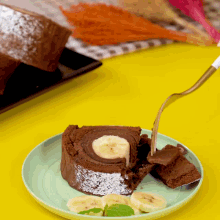 a slice of chocolate cake with bananas on it on a plate