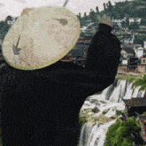 a person wearing a hat with a leaf on it
