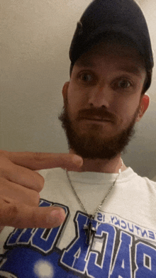 a man with a beard is wearing a shirt that says ' duke ' on it