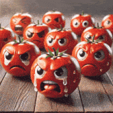 a group of tomatoes with different faces on them