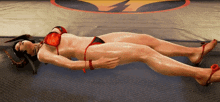 a woman in a bikini is laying on the ground