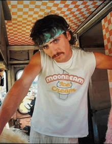 a man wearing a shirt that says moonbeam ice cream on it