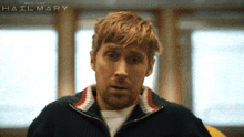 a man in a sweater with the word project hailmary on the bottom right