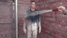 a man is being sprayed with a hose with the words mr.wam written on the bottom