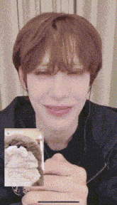a close up of a person 's face holding a card