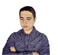 a man with his arms crossed is wearing a blue shirt with a pattern