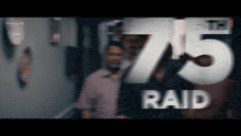 a blurred image of a group of people with the number 75 raid on it