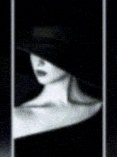 a woman in a black hat is taking a picture of herself