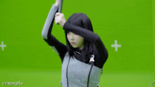 a woman is holding a sword in front of a green screen with aespagifs written on it