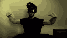 a man flexing his muscles wearing a military hat and goggles
