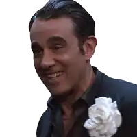 a man with a white flower in his pocket smiles for the camera