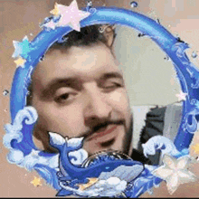 a man with a beard is surrounded by a blue frame with a whale in it .
