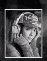 a woman wearing headphones and a hat that says " rock "
