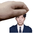 a hand is holding a man 's head in a pixel art style .