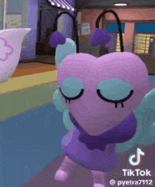 a purple heart with wings and a bow on its head is dancing in a video game .