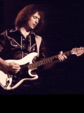 a man playing a guitar with the name bukusum on the bottom right