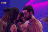 a man and a woman are standing next to each other in a room .