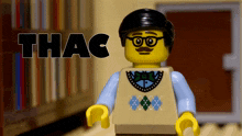 a lego man with glasses and a mustache is standing in front of a bookshelf and says thac