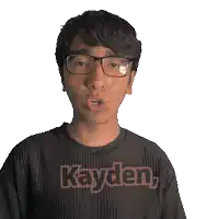 a young man wearing glasses and a black shirt that says kayden