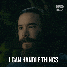 a man with a beard says " i can handle things " in a dark room
