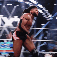 a shirtless wrestler is in a ring with the watermark tiffanyluv24 on the bottom