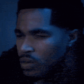 a blurry picture of a man 's face with a few yellow lights in the foreground