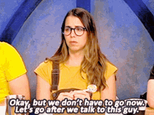 a woman with glasses is holding a lollipop and saying okay but we don 't have to go now