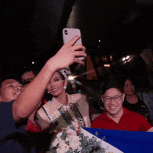 a woman is taking a selfie with her phone