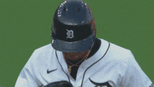 a baseball player wearing a helmet that has the letter d on it
